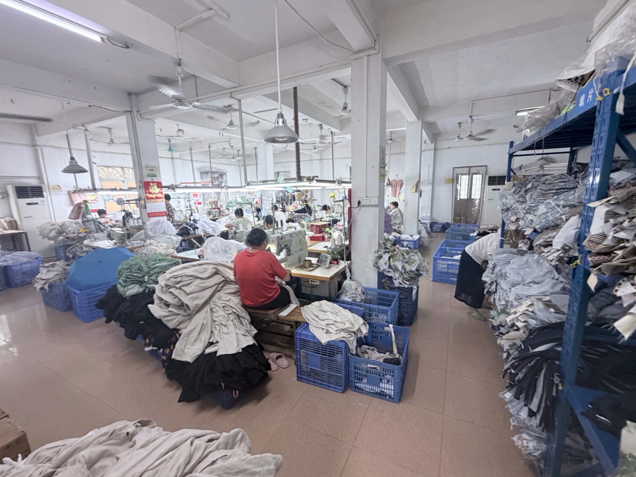 Jinfengtu Apparel sewing floor with production operators, sewing stations and in-process garments